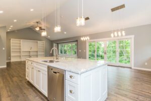 A Large Kitchen With Living Space With a White Island