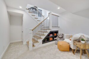 A Staircase With White Banisters and Iron Railing