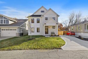 A White Color House With a Roof With a Lawn