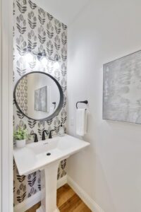 A Long Standing White Sink on a Wall With Leave Pattern