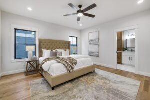 A White Comforter and Bed With Brown Color Bed Frame