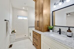 A Bathroom With Wood and White Cabinets